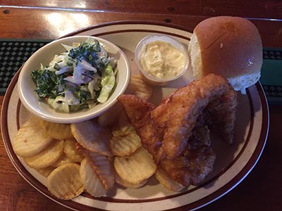 Branding Iron Roadhouse fish fry with fries, coleslaw, bread and sauce